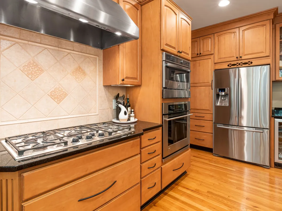 Kitchen with a stainless steel French-door refrigerator, built-in double oven and gas cooktop