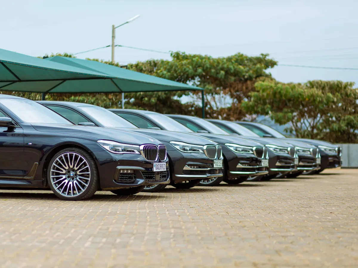 Rows of new cars on display inside a car dealership showroom
