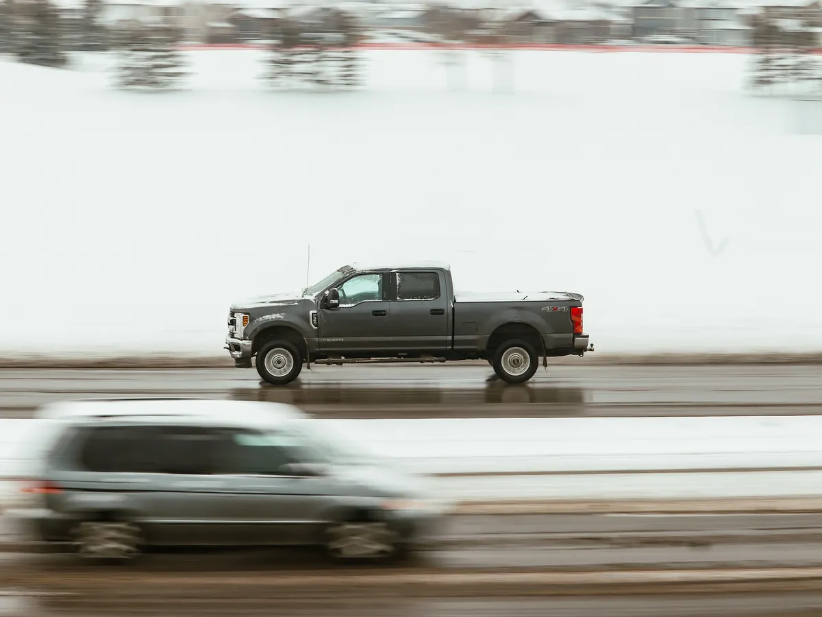 Pickup truck in motion on a highway at dusk