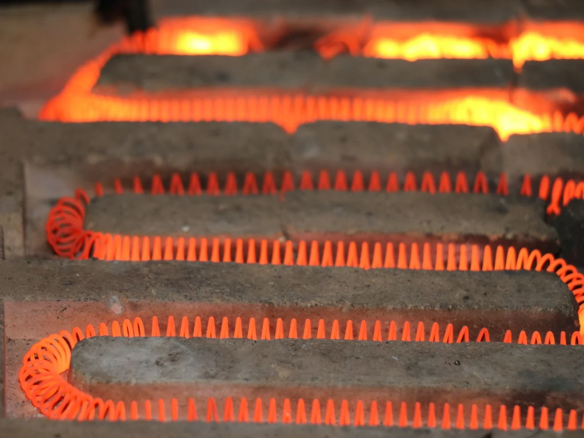 Electric heating element glowing orange, the same principle a hot-surface furnace igniter uses