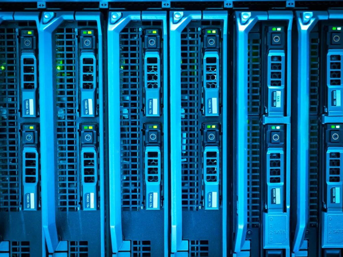 Rows of server drive bays with green status lights inside a data center rack