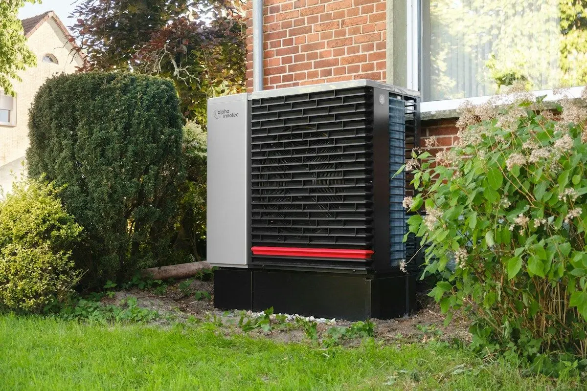 Modern heat pump outdoor unit in a residential garden