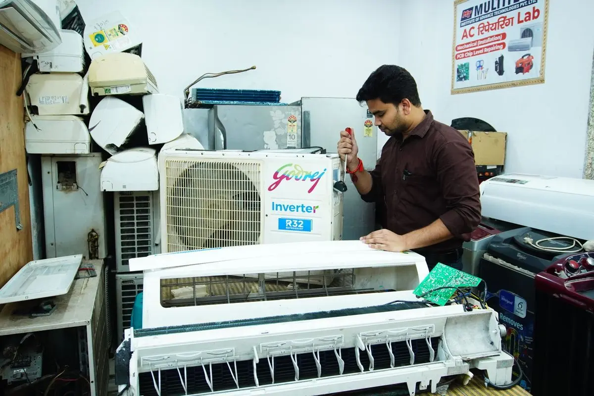 Technician servicing a ductless mini-split air conditioner