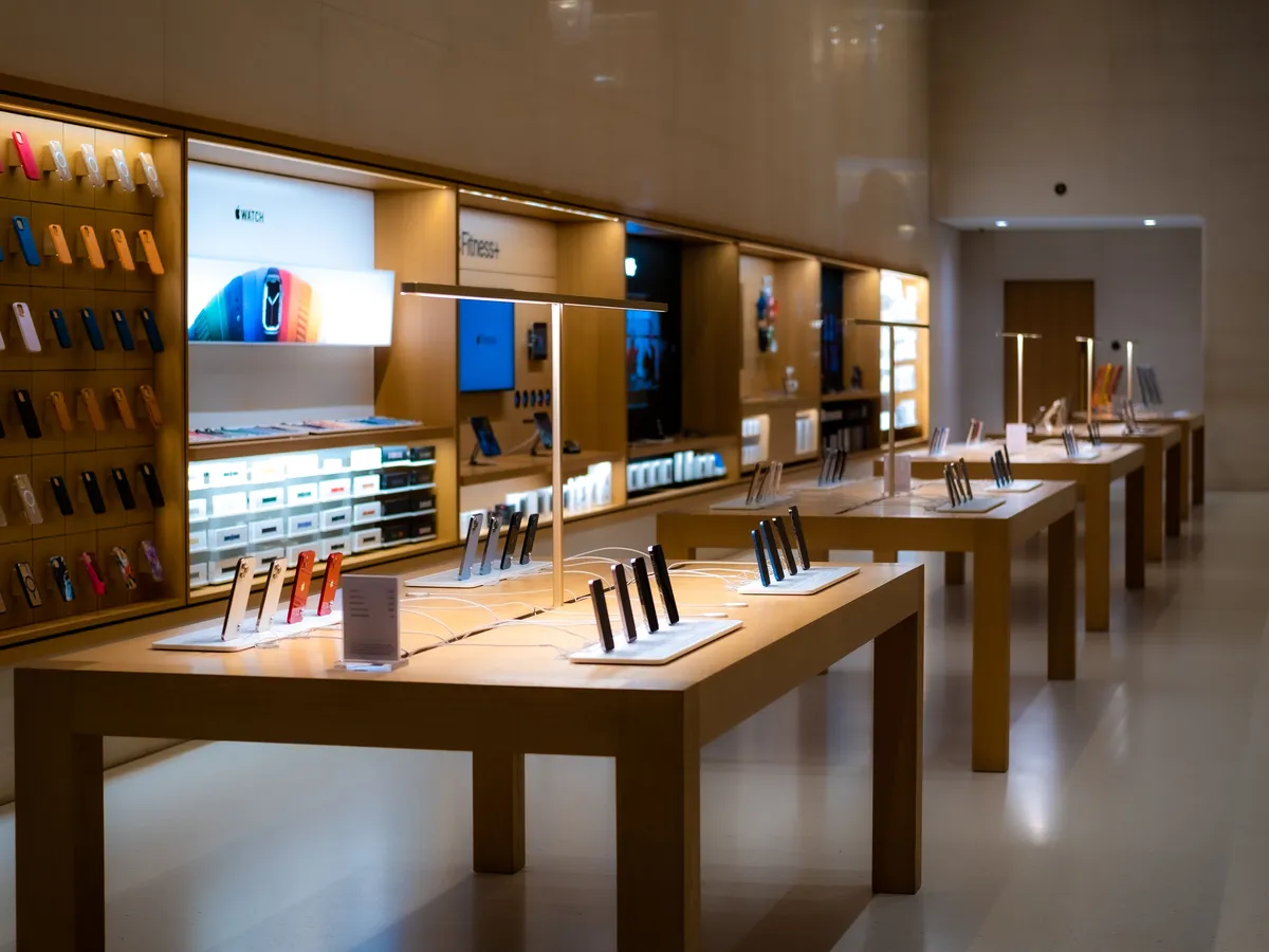 Rows of smartphones on display tables and shelves in a mobile phone store