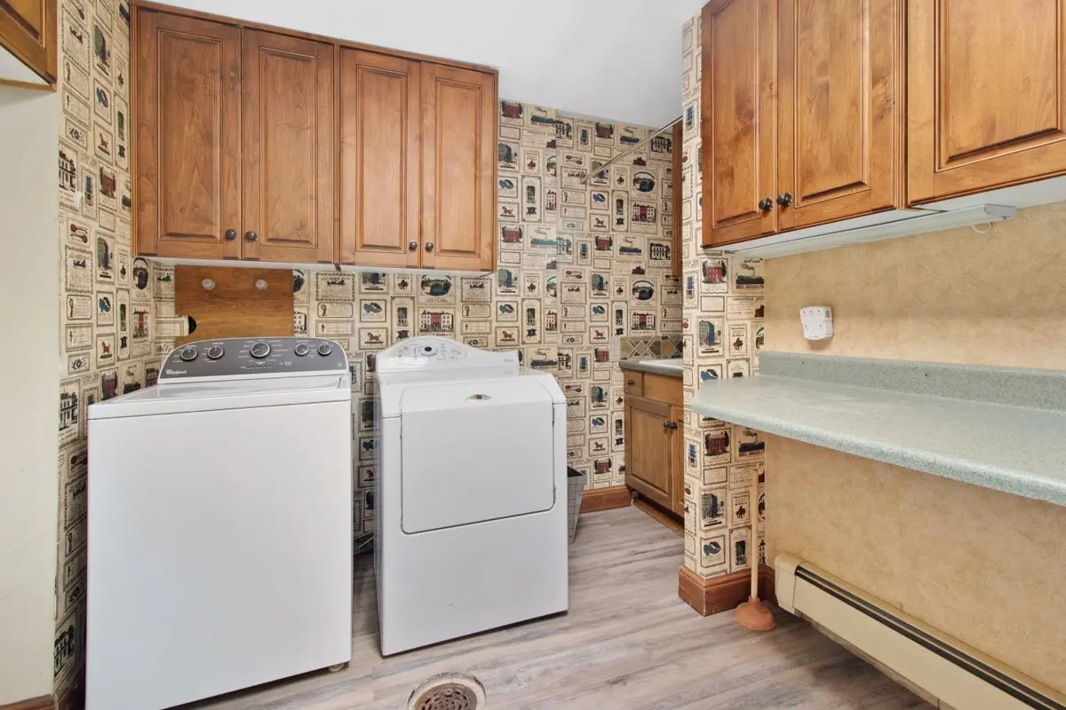 Washer and dryer side by side in a home laundry room