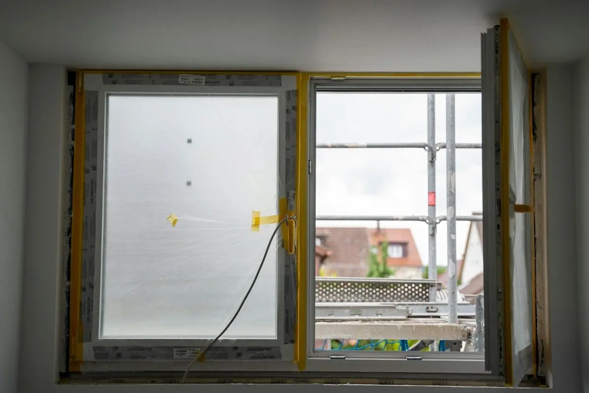 New replacement window being fitted into a wall opening